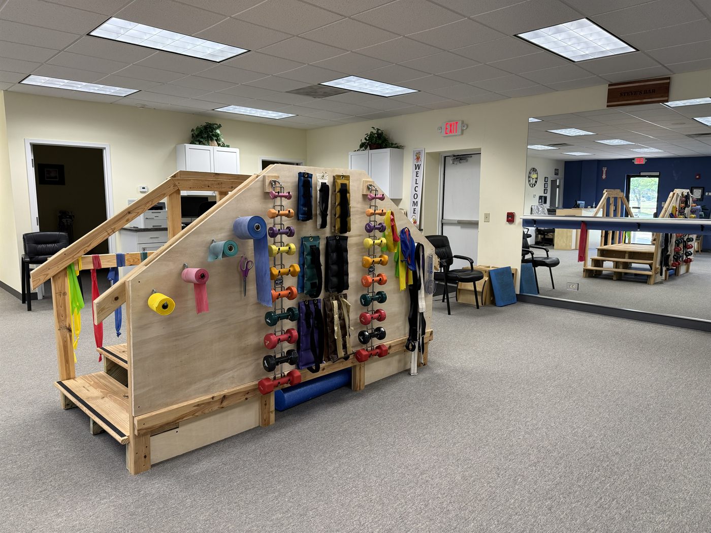 Stairs, balance bars, resistance bands, and weights in the clinic exercise area